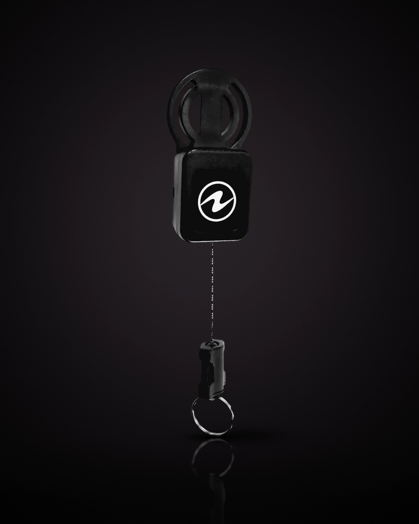 Aqualung Compass Retractor Kit: a black retractor with a white Aqualung logo, a round clip on top, and a thin cord pulled out below, ending in a connector with a metal ring